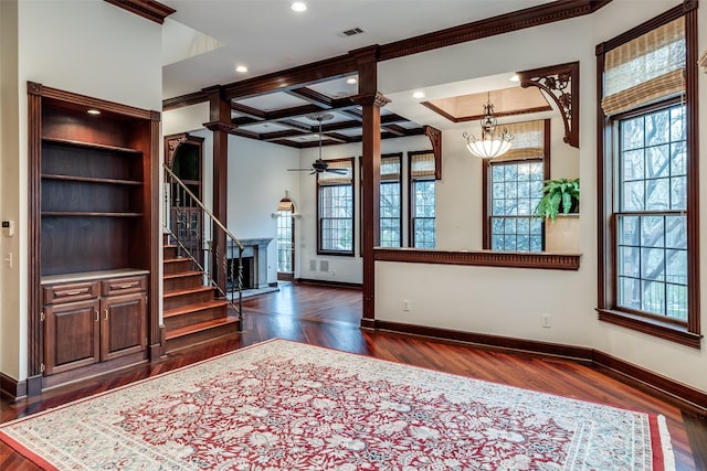 unfurnished living room with a healthy amount of sunlight, baseboards, ornamental molding, and a ceiling fan