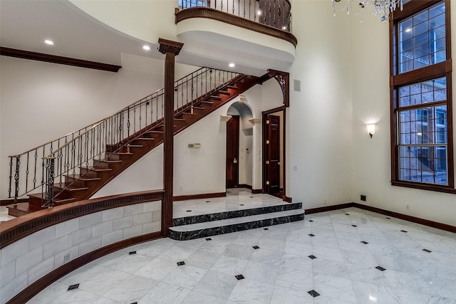 entryway featuring visible vents, stairs, baseboards, a high ceiling, and recessed lighting