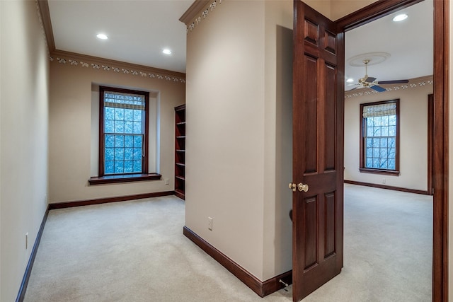 hall featuring crown molding, baseboards, light carpet, and recessed lighting