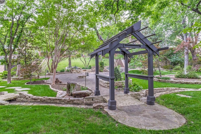 view of community with a lawn and a patio area