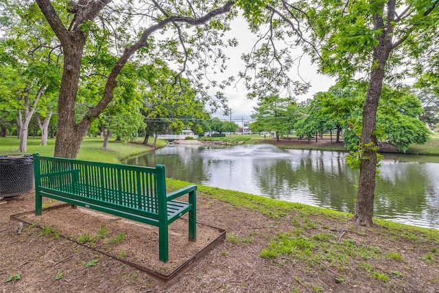 view of property's community with a water view and a yard