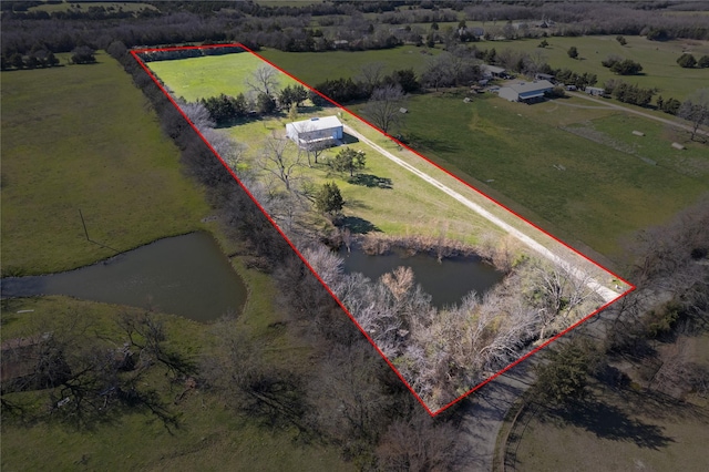 birds eye view of property featuring a water view and a rural view