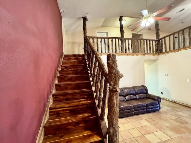 stairs featuring lofted ceiling, a ceiling fan, and tile patterned floors