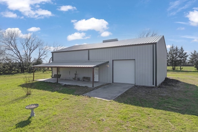 view of pole building with a lawn and driveway