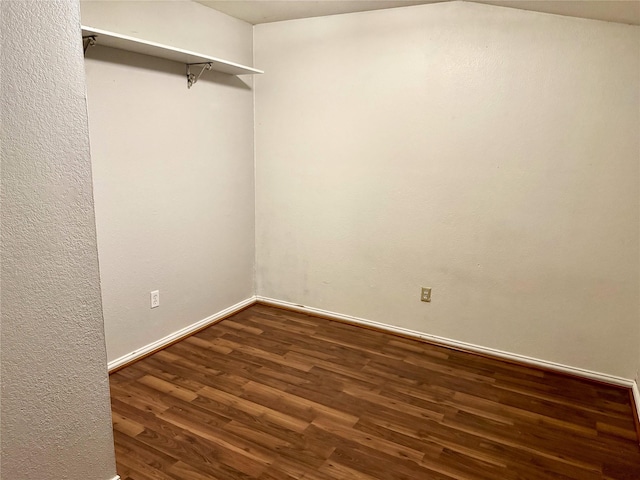 walk in closet with wood finished floors