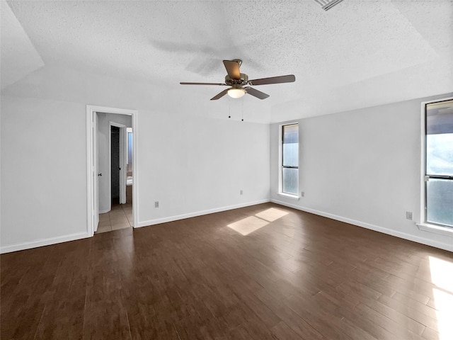 empty room featuring baseboards, a textured ceiling, a ceiling fan, and wood finished floors