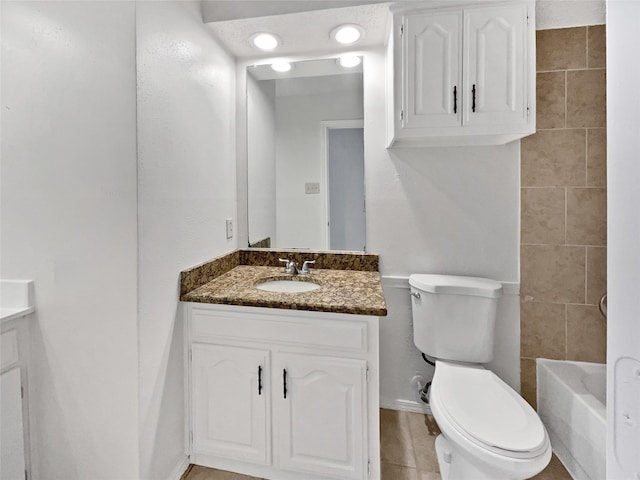 full bathroom with toilet, vanity, and a washtub
