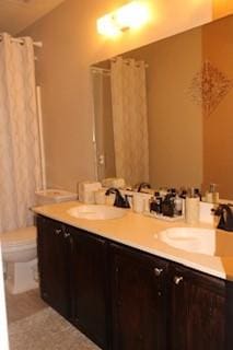 1124 Mazourka Dr, Arlington, TX 76001 - full bath featuring a sink, toilet, and double vanity