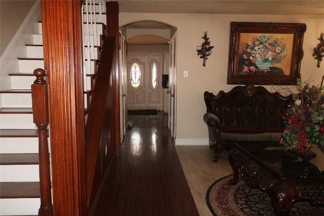 1124 Mazourka Dr, Arlington, TX 76001 - foyer entrance with stairway, arched walkways, baseboards, and dark wood-style floors