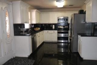 1124 Mazourka Dr, Arlington, TX 76001 - kitchen with white cabinetry, dark countertops, tasteful backsplash, and appliances with stainless steel finishes