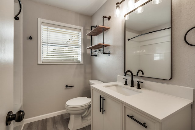 411 N 5th Ave, Munday, TX 76371 - bathroom with baseboards, toilet, wood finished floors, vanity, and a shower