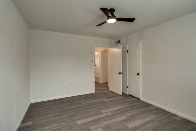 411 N 5th Ave, Munday, TX 76371 - empty room with visible vents, baseboards, wood finished floors, and a ceiling fan