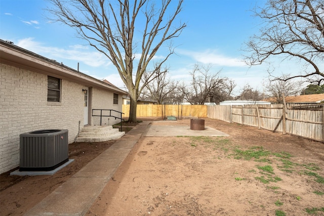 411 N 5th Ave, Munday, TX 76371 - view of yard with a fenced backyard, a patio, and central AC