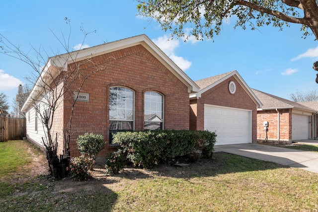 single story home featuring brick siding, driveway, a front yard, and a garage