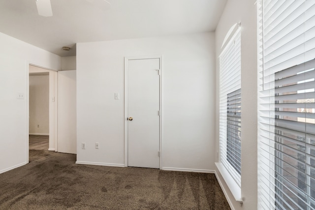 unfurnished bedroom featuring carpet flooring, a ceiling fan, and baseboards