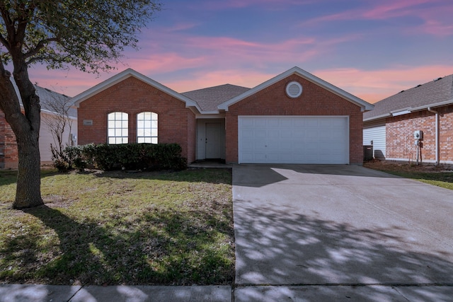 ranch-style house with a front yard, an attached garage, brick siding, and driveway