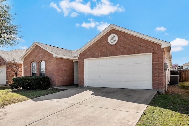 single story home featuring a garage, brick siding, and driveway