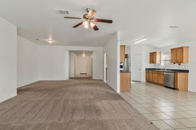 unfurnished living room featuring lofted ceiling, light tile patterned floors, a ceiling fan, and visible vents