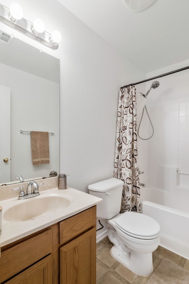 bathroom featuring shower / bath combo with shower curtain, visible vents, toilet, and vanity