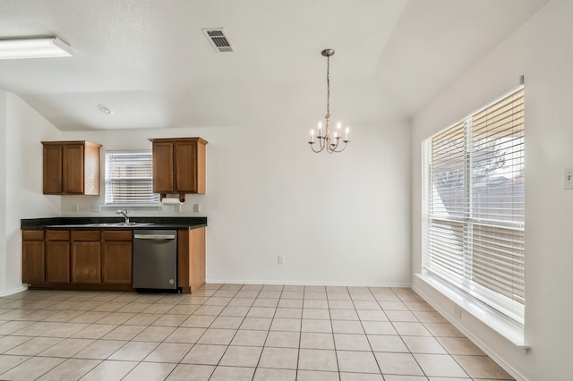 kitchen with dark countertops, visible vents, light tile patterned flooring, a notable chandelier, and stainless steel dishwasher