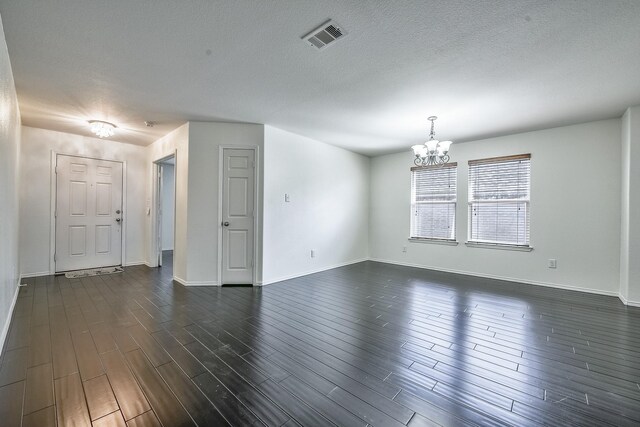 2444 Horseback Trl, Fort Worth, TX 76177 - spare room featuring a chandelier, baseboards, dark wood finished floors, and a textured ceiling