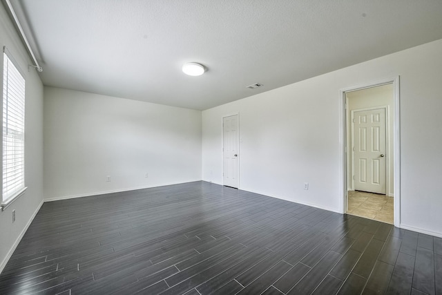 2444 Horseback Trl, Fort Worth, TX 76177 - spare room with dark wood-style floors, plenty of natural light, and baseboards