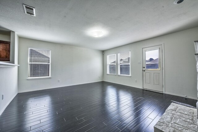 2444 Horseback Trl, Fort Worth, TX 76177 - spare room featuring dark wood finished floors, a textured ceiling, and baseboards
