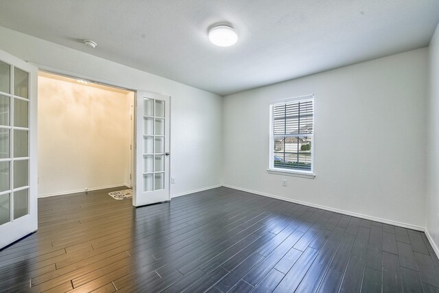 2444 Horseback Trl, Fort Worth, TX 76177 - empty room with french doors, dark wood finished floors, a smoke detector, and baseboards