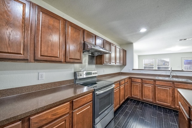 2444 Horseback Trl, Fort Worth, TX 76177 - kitchen with stainless steel range with electric stovetop, under cabinet range hood, a sink, a textured ceiling, and dark countertops