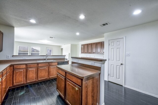 2444 Horseback Trl, Fort Worth, TX 76177 - kitchen with a sink, dark wood-style flooring, a kitchen island, recessed lighting, and a peninsula