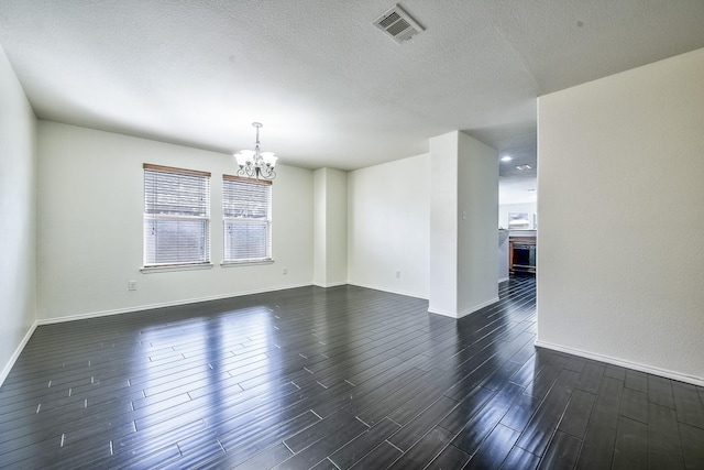 2444 Horseback Trl, Fort Worth, TX 76177 - unfurnished room featuring a chandelier, dark wood-style floors, baseboards, and a textured ceiling