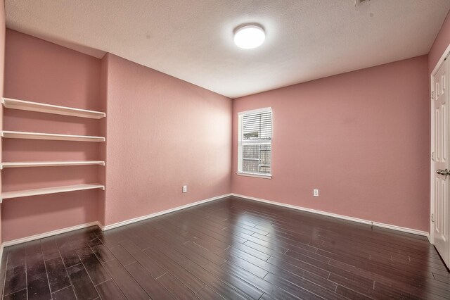 2444 Horseback Trl, Fort Worth, TX 76177 - unfurnished room with wood finished floors, baseboards, and a textured ceiling