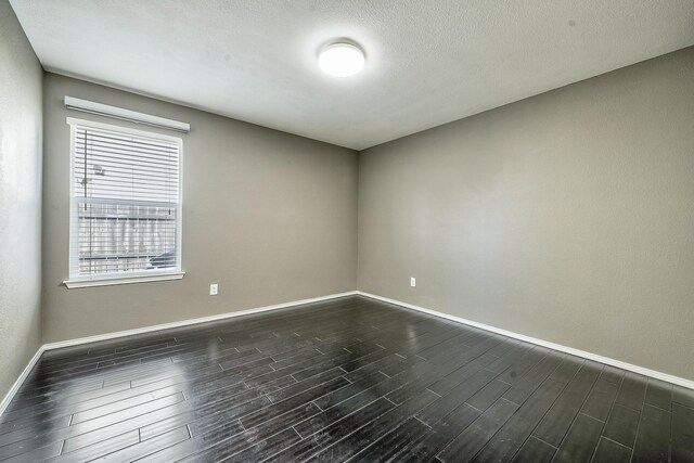 2444 Horseback Trl, Fort Worth, TX 76177 - unfurnished room with baseboards, plenty of natural light, and dark wood-type flooring