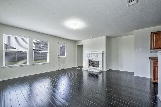 2444 Horseback Trl, Fort Worth, TX 76177 - unfurnished living room with a fireplace, dark wood-style flooring, baseboards, and a textured ceiling