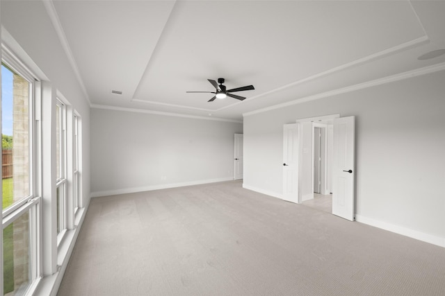 7127 Seagrove Ct, Grand Prairie, TX 75054 - spare room featuring light colored carpet, a tray ceiling, ornamental molding, and ceiling fan