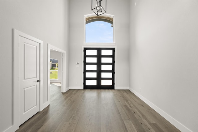 7127 Seagrove Ct, Grand Prairie, TX 75054 - entrance foyer featuring a chandelier, dark wood-type flooring, a high ceiling, and french doors