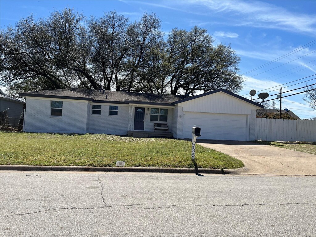 785 Betty Ln, Hurst, TX 76053 - single story home with driveway, fence, an attached garage, a front yard, and brick siding
