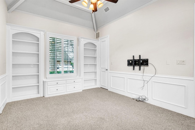 interior space featuring visible vents, built in features, lofted ceiling, carpet floors, and a ceiling fan