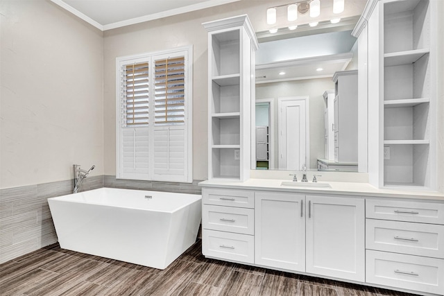 full bath with vanity, wood tiled floor, a freestanding tub, and ornamental molding