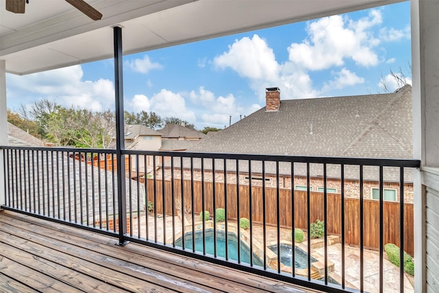 deck featuring a fenced in pool, a ceiling fan, and fence