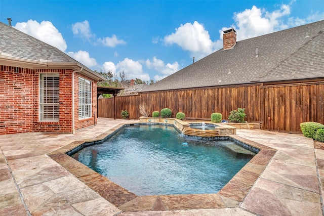 view of pool with a pool with connected hot tub, a patio area, and a fenced backyard