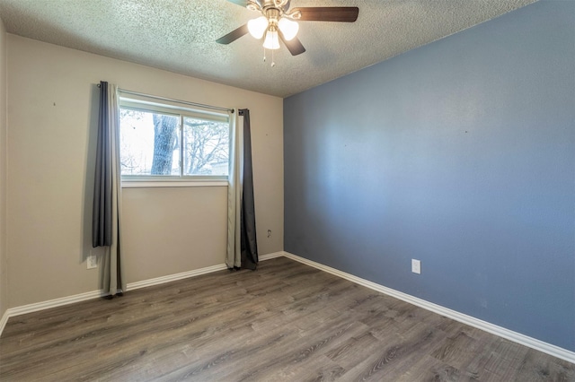 empty room featuring ceiling fan, wood finished floors, baseboards, and a textured ceiling