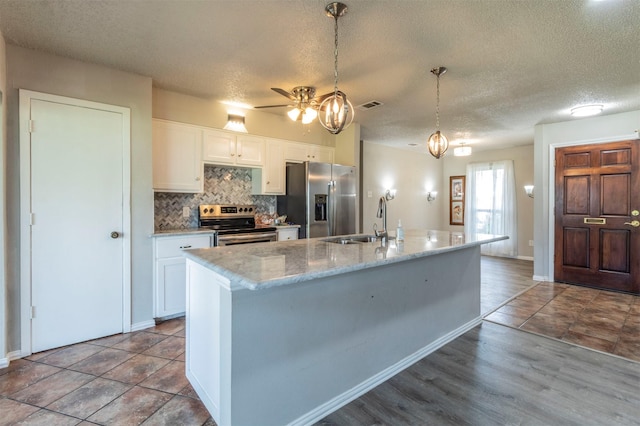 kitchen with white cabinets, backsplash, appliances with stainless steel finishes, and a sink