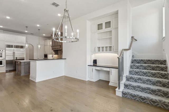 3668 Torrance Blvd, Frisco, TX 75034 - kitchen featuring visible vents, wood finished floors, recessed lighting, tasteful backsplash, and stainless steel appliances