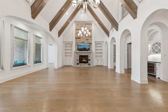 3668 Torrance Blvd, Frisco, TX 75034 - unfurnished living room with beverage cooler, high vaulted ceiling, built in features, light wood-type flooring, and beamed ceiling