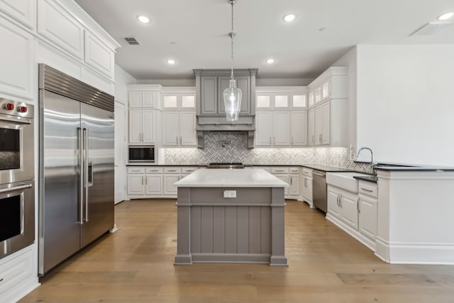 3668 Torrance Blvd, Frisco, TX 75034 - unfurnished living room with light wood-style floors, high vaulted ceiling, built in shelves, wine cooler, and beamed ceiling