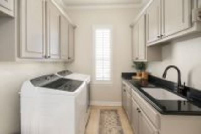 156 Stoneleigh Dr, Heath, TX 75032 - laundry room featuring independent washer and dryer, cabinet space, and crown molding