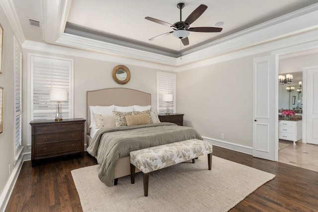 156 Stoneleigh Dr, Heath, TX 75032 - bedroom with crown molding, dark wood-type flooring, a tray ceiling, a chandelier, and baseboards