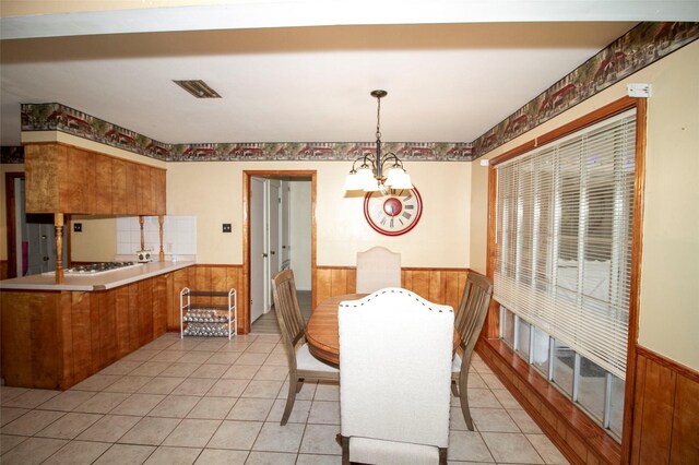 9613 Royalton Dr, Shreveport, LA 71118 - dining room with visible vents, wooden walls, and wainscoting