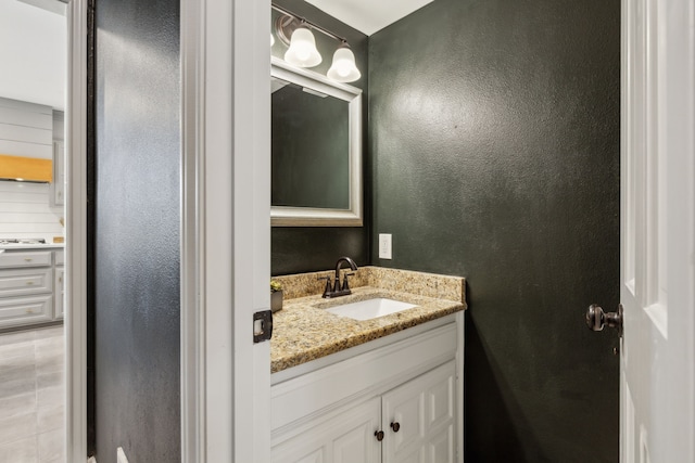 bathroom featuring vanity and a textured wall